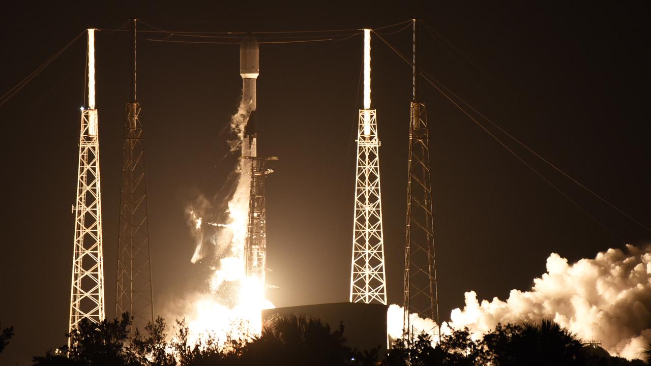 SpaceX's space shuttle launched at the spaceport at night is visible.