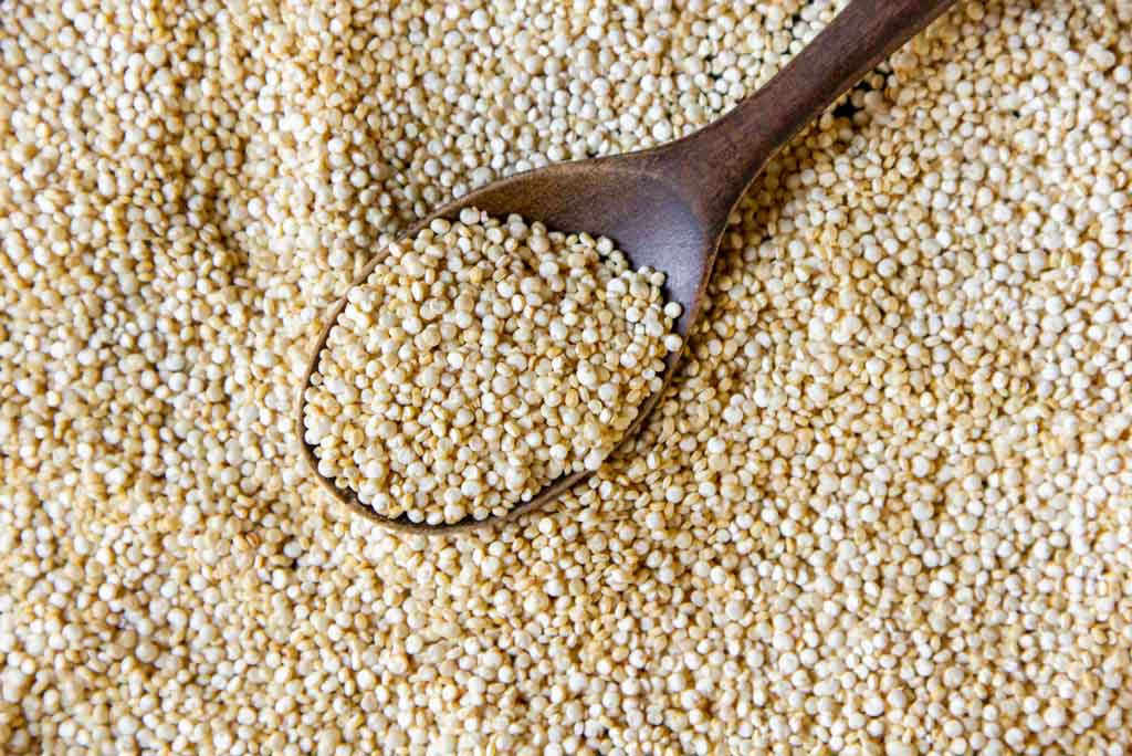 The image shows quinoa as a high fiber food.