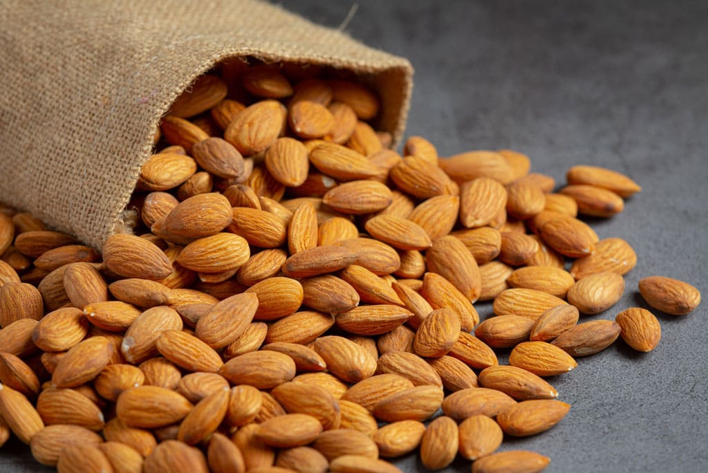 The image shows almonds as a high fiber food.