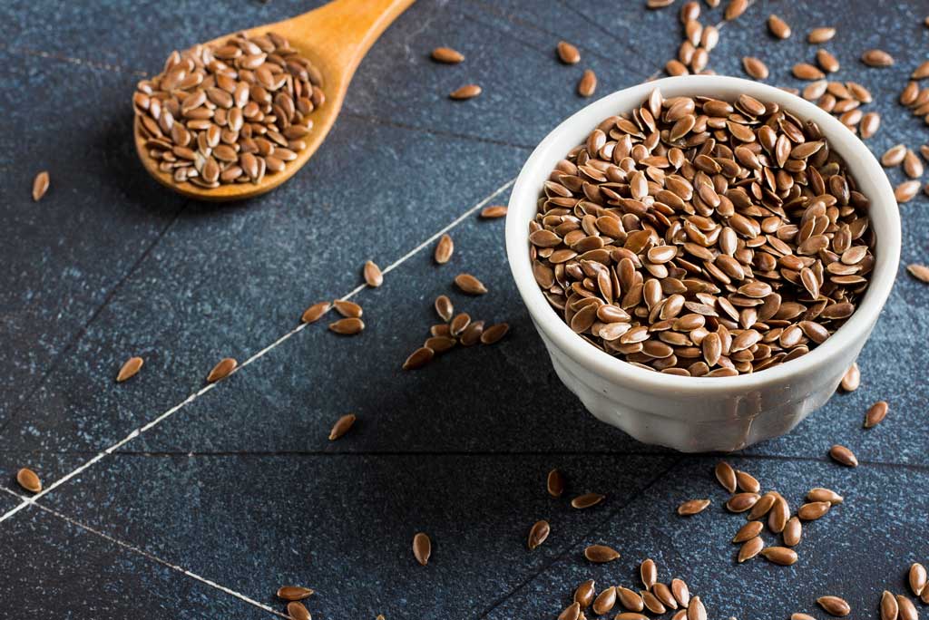 The image shows flaxseed as a high fiber food.