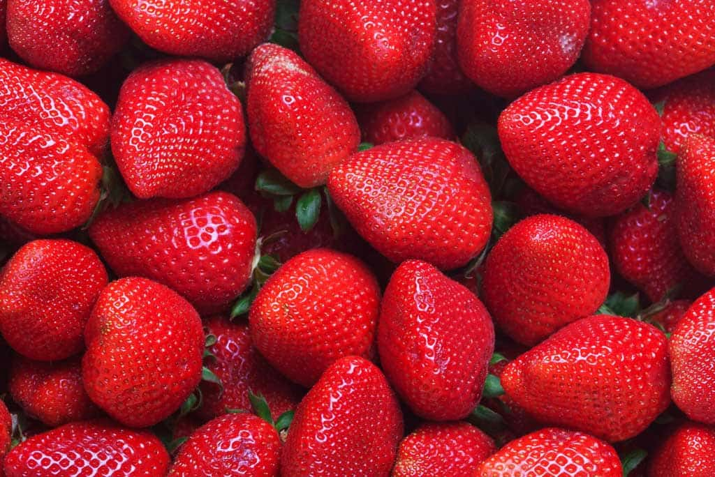 The image shows strawberries as a high fiber food.